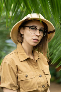 Portrait of young woman wearing hat in park