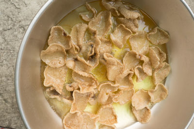 Directly above shot of potato chips in wok on table