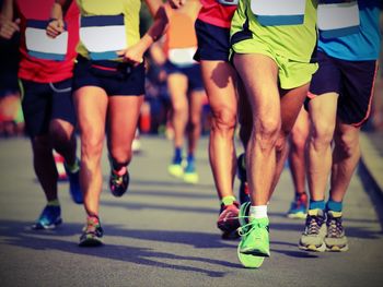 Low section of people running on road