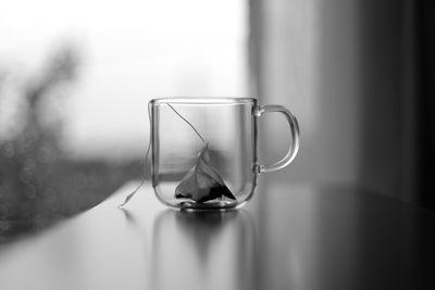 Close-up of cup with teabag on table 