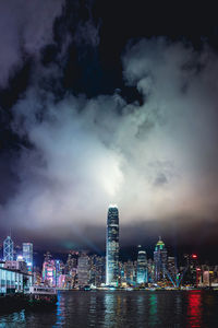 Illuminated cityscape against sky at night