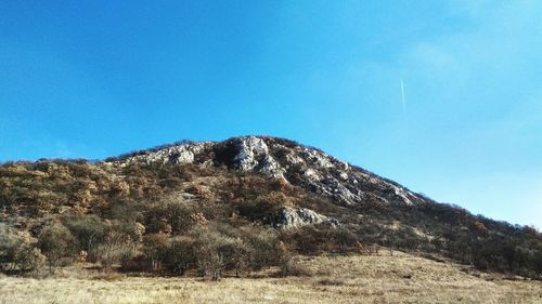 Low angle view of mountain against clear blue sky