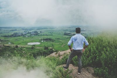 Rear view of man looking at landscape