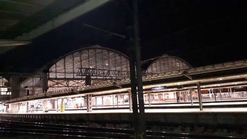 Train at railroad station platform at night