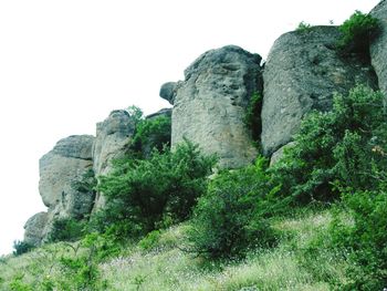 Low angle view of rock formation against clear sky