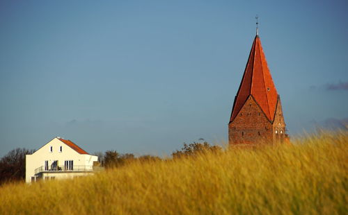 House on field against sky