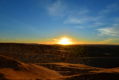 Scenic view of field against sky during sunset