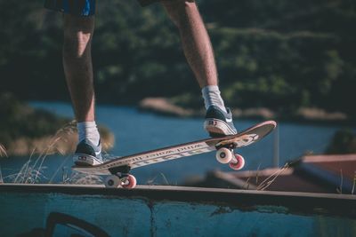 Low section of man skateboarding on skateboard