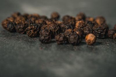 Close-up of black peppers on table