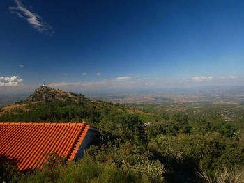 Scenic view of landscape and houses against sky