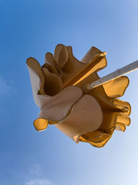 Low angle view of red balloons against blue sky