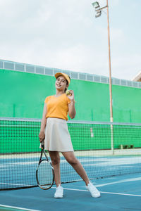 Portrait of young woman playing tennis