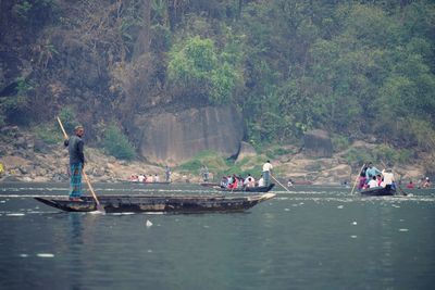 People on river against trees