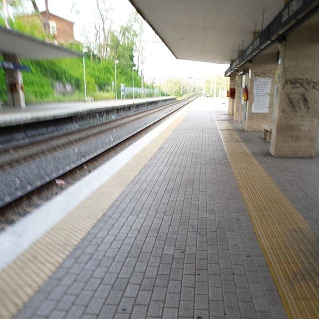 transportation, the way forward, railroad track, diminishing perspective, vanishing point, rail transportation, built structure, public transportation, railroad station platform, architecture, empty, long, railroad station, surface level, railway track, straight, incidental people, day, building exterior, no people