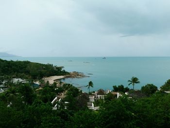 High angle view of buildings by sea against sky