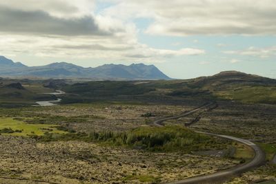 Scenic view of mountains against cloudy sky