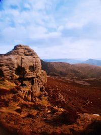 Rock formations on landscape against sky