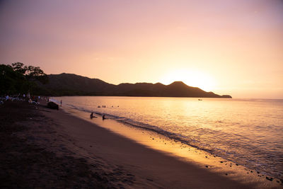 Scenic view of beach against sky during sunset