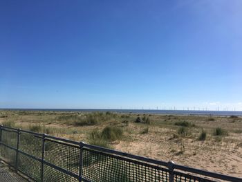 Scenic view of landscape against clear blue sky