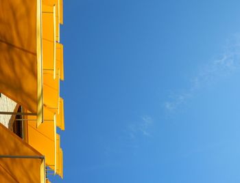 Low angle view of yellow building against sky