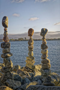 Close-up of rocks on beach against sky