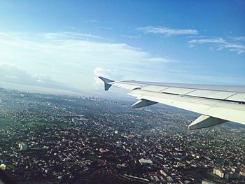 Aerial view of aircraft wing seen through airplane window