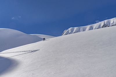 Low angle view of snowcapped mountain against sky