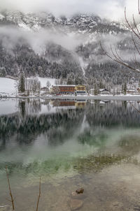 Scenic view of river against sky during winter