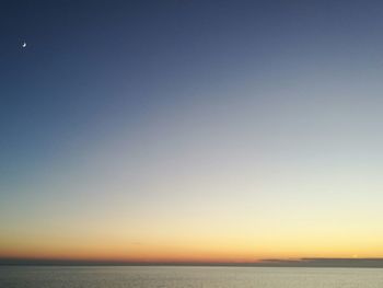 Scenic view of sea against clear sky during sunset