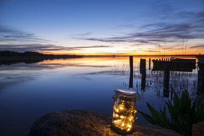 Scenic view of lake against sky during sunset