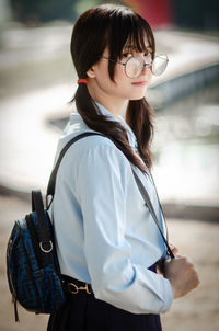 Girl wearing hat standing outdoors