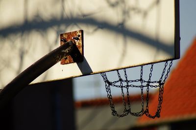 Low angle view of basketball hoop against fence