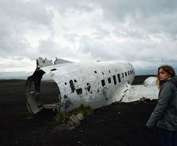 Woman standing on abandoned airplane