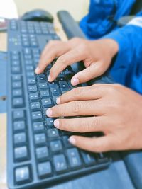 Midsection of woman using laptop