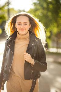 Portrait of young woman standing outdoors