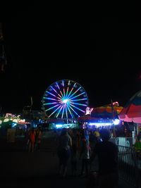 Illuminated ferris wheel at night