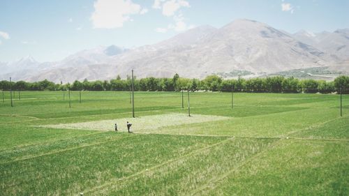 Countryside landscape against mountain range