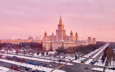 Tender sunrize over winter sunny campus of moscow universities with snow covered bare trees