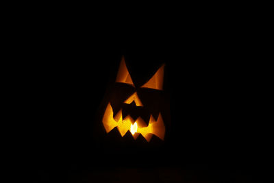 Close-up of illuminated pumpkin against black background