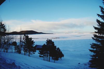 Scenic view of snow covered landscape against sky