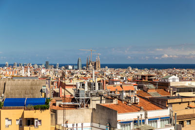 High angle view of townscape by sea against sky