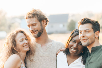 Portrait of smiling friends standing outdoors