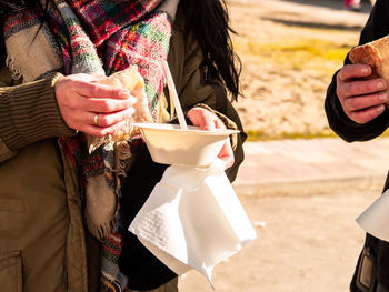 Midsection of woman holding ice cream cone