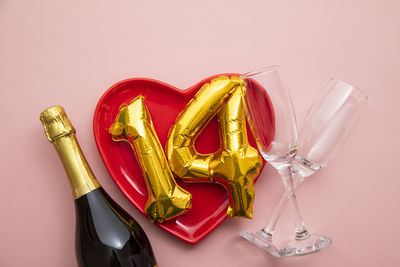 High angle view of christmas decorations against pink background