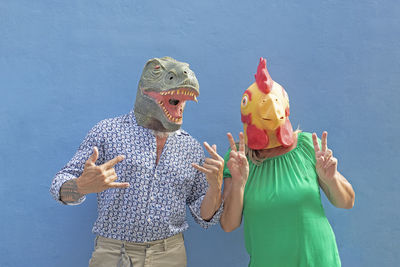 Low angle view of woman holding mask