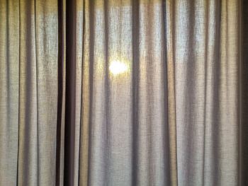 Close-up of curtain against window at home