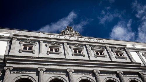 Low angle view of building against cloudy sky