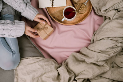 High angle view of man sitting on bed at home