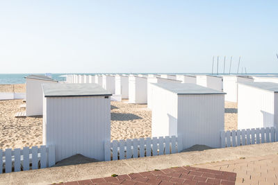 Built structure on beach against clear sky
