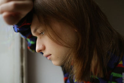 Close-up of thoughtful man with long hair